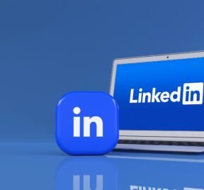 3D rendering of two LInkedin square badges in front of a noteboo